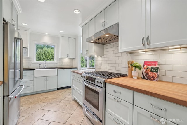 16255 38th Ave NE, Lake Forest Park, WA 98155 - kitchen featuring stainless steel appliances, under cabinet range hood, a sink, tasteful backsplash, and butcher block counters
