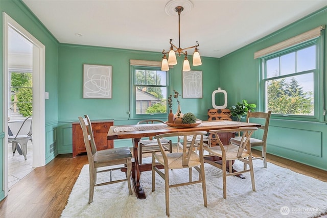 16255 38th Ave NE, Lake Forest Park, WA 98155 - dining area with plenty of natural light, a chandelier, wood finished floors, crown molding, and a wainscoted wall