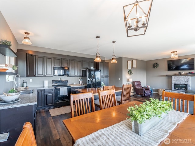 202 Chipmunk Trail Rd, East Wenatchee, WA 98802 - dining space with a fireplace, dark wood finished floors, and a chandelier