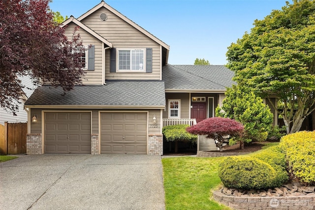 7725 Perregrine Pl, Arlington, WA 98223 - split level home with concrete driveway, an attached garage, and a shingled roof