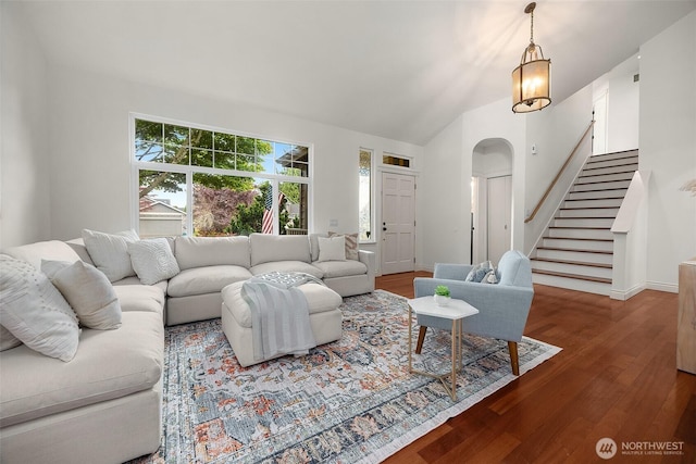 7725 Perregrine Pl, Arlington, WA 98223 - living area featuring wood finished floors, stairway, arched walkways, vaulted ceiling, and baseboards