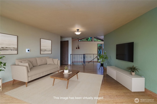 15127 Gibralter Rd, Anacortes, WA 98221 - living area featuring wood finished floors, baseboards, and vaulted ceiling
