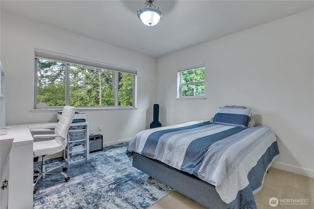 bedroom featuring baseboards and a desk