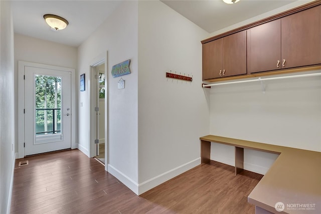 mudroom with wood finished floors and baseboards