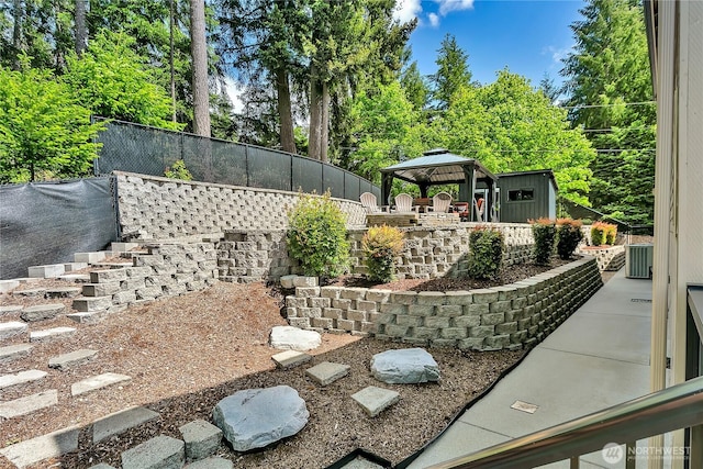 view of yard with a gazebo, fence, and central air condition unit