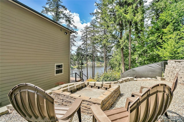 view of patio / terrace featuring a water view and view of scattered trees