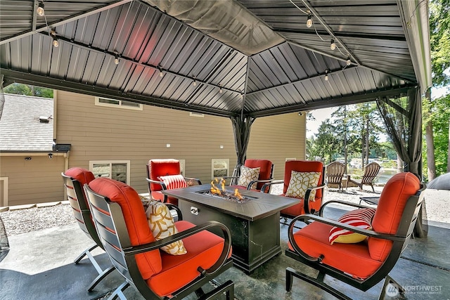 view of patio featuring a fire pit and a gazebo