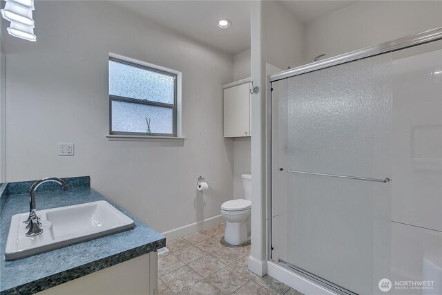 5205 Rehklau Rd SE, Olympia, WA 98513 - bathroom with a shower stall, toilet, vanity, baseboards, and recessed lighting
