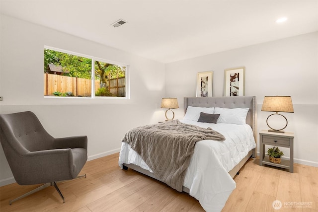 bedroom featuring baseboards and wood finished floors