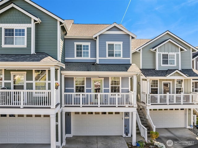 coastal home featuring a shingled roof, an attached garage, concrete driveway, and covered porch