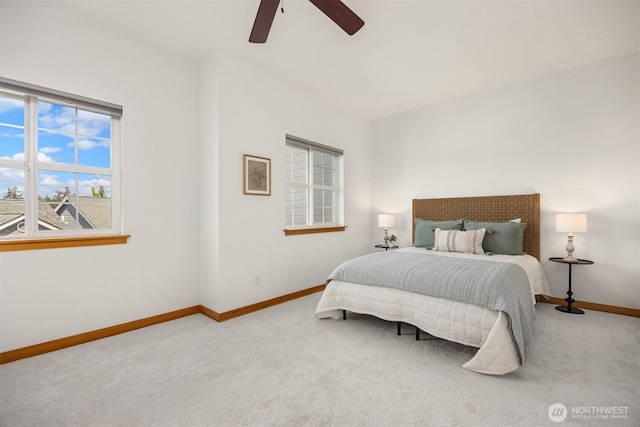 carpeted bedroom featuring baseboards and a ceiling fan