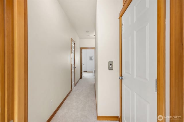 hall with light carpet and baseboards