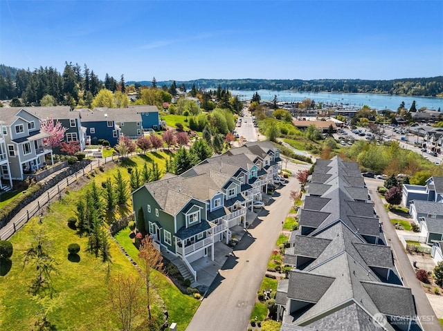 aerial perspective of suburban area with a nearby body of water
