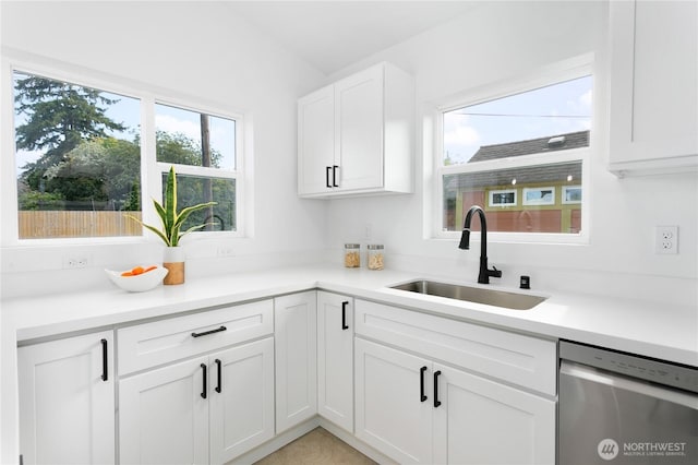 2805 S 11th St, Tacoma, WA 98405 - kitchen featuring stainless steel dishwasher, a sink, white cabinets, and light countertops