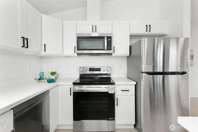 2805 S 11th St, Tacoma, WA 98405 - kitchen with stainless steel appliances, white cabinets, light countertops, and vaulted ceiling