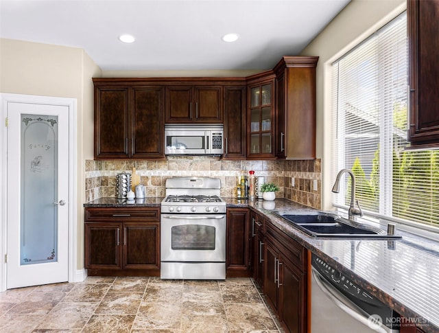 7911 Oregon Trl, Maple Falls, WA 98266 - kitchen with stainless steel appliances, a sink, tasteful backsplash, glass insert cabinets, and dark brown cabinets
