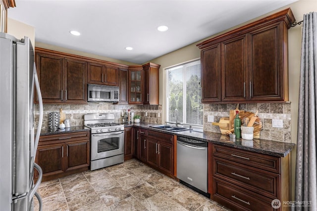 7911 Oregon Trl, Maple Falls, WA 98266 - kitchen with stainless steel appliances, a sink, backsplash, recessed lighting, and glass insert cabinets