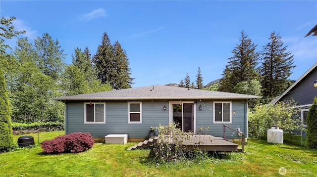 7911 Oregon Trl, Maple Falls, WA 98266 - rear view of house featuring a deck and a lawn