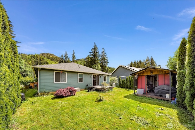 7911 Oregon Trl, Maple Falls, WA 98266 - rear view of property featuring a yard and a deck