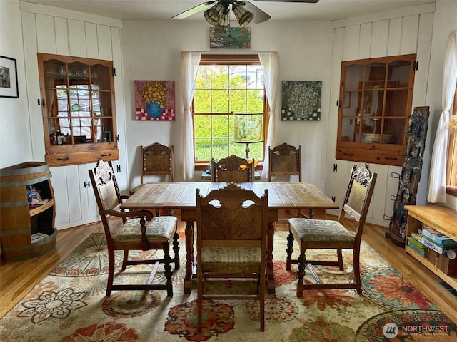 dining room with wood finished floors and ceiling fan