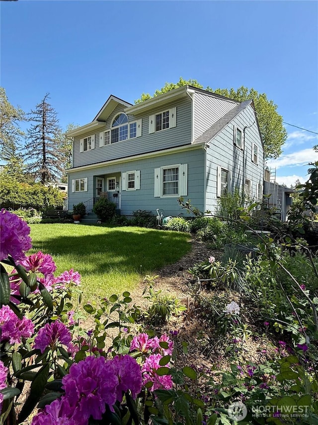 colonial-style house with a front yard
