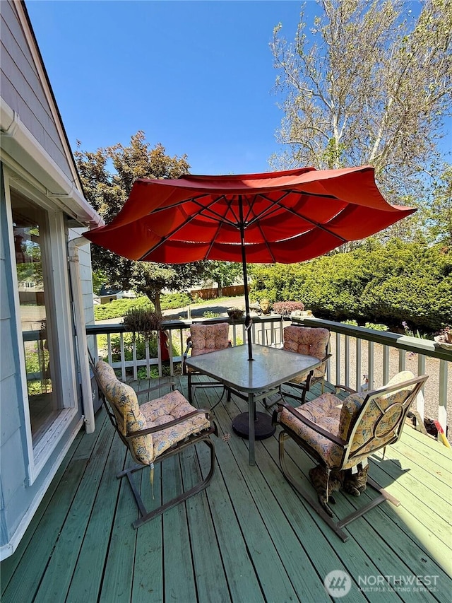 wooden terrace featuring outdoor dining area