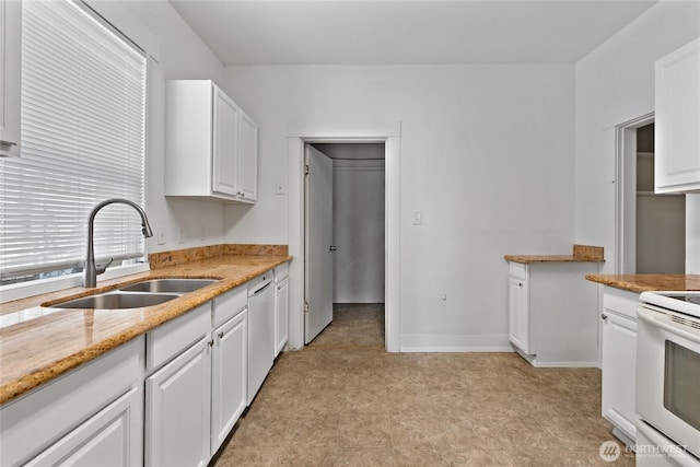 310 S 28th St, Tacoma, WA 98402 - kitchen with a sink, electric stove, light flooring, dishwashing machine, and white cabinetry