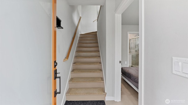 staircase featuring baseboards