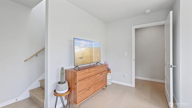 bedroom with light wood-style flooring and baseboards
