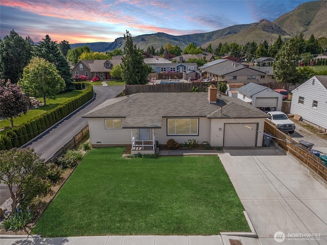 1819 Springwater Ave, Wenatchee, WA 98801 - ranch-style home featuring a mountain view, concrete driveway, a garage, a chimney, and a residential view