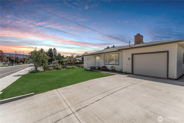 1819 Springwater Ave, Wenatchee, WA 98801 - view of front facade with a garage, a yard, a chimney, and concrete driveway