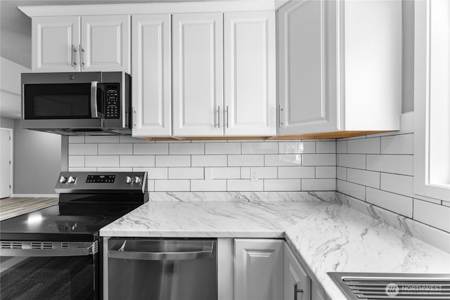 1819 Springwater Ave, Wenatchee, WA 98801 - kitchen with stainless steel appliances, white cabinets, backsplash, and light stone countertops