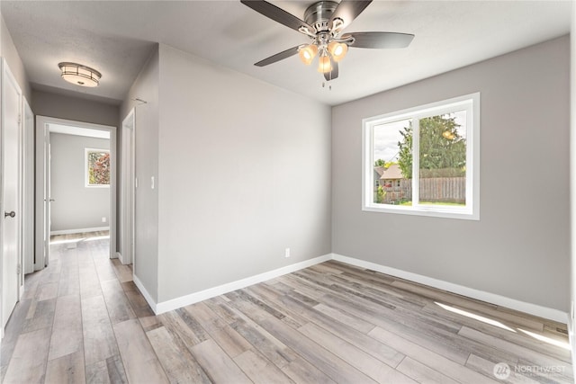 1819 Springwater Ave, Wenatchee, WA 98801 - empty room featuring light wood-style flooring, baseboards, and a ceiling fan