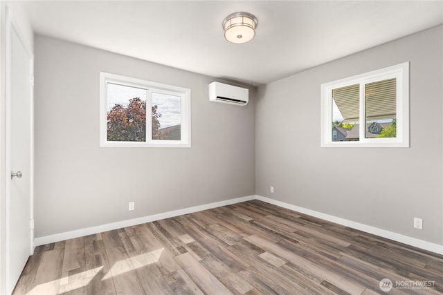 1819 Springwater Ave, Wenatchee, WA 98801 - unfurnished room with a wall mounted AC, wood finished floors, and baseboards