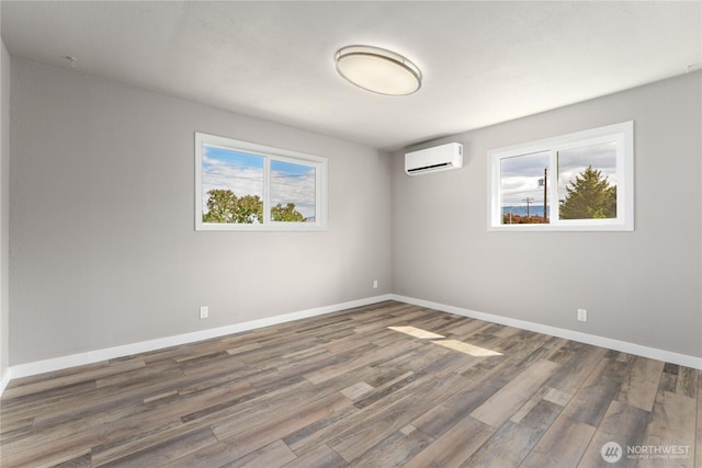 1819 Springwater Ave, Wenatchee, WA 98801 - unfurnished room with a wall mounted AC, wood finished floors, plenty of natural light, and baseboards
