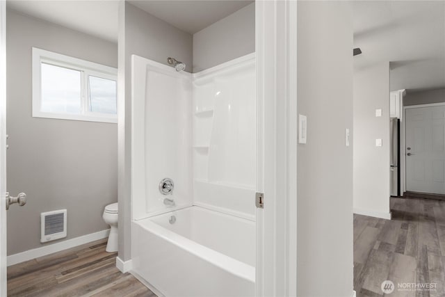 1819 Springwater Ave, Wenatchee, WA 98801 - full bathroom with toilet, baseboards, wood finished floors, and shower / tub combination