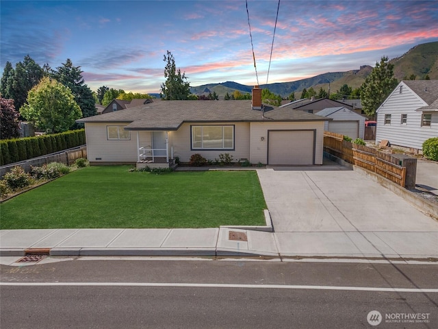 1819 Springwater Ave, Wenatchee, WA 98801 - ranch-style house featuring a garage, concrete driveway, a mountain view, and a chimney