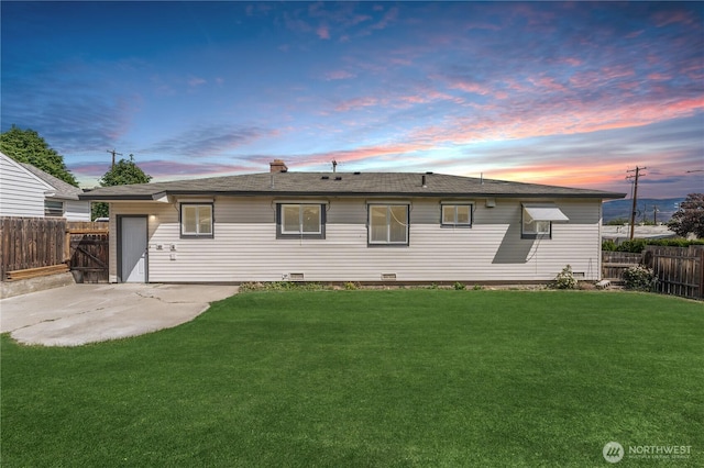 1819 Springwater Ave, Wenatchee, WA 98801 - back of property at dusk featuring a patio and a chimney