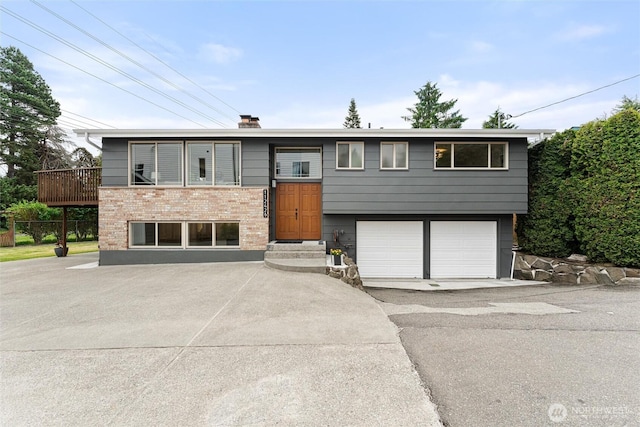 11242 Fremont Ave N Unit B, Seattle, WA 98133 - raised ranch featuring brick siding, an attached garage, a chimney, and asphalt driveway