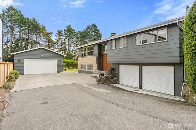 11242 Fremont Ave N Unit B, Seattle, WA 98133 - split foyer home with a chimney, an outdoor structure, and a detached garage