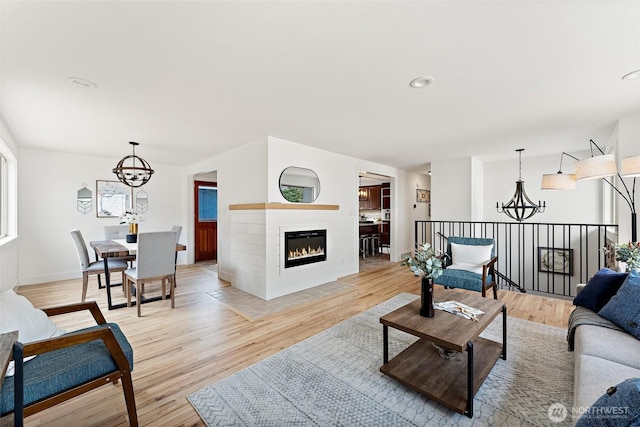 11242 Fremont Ave N Unit B, Seattle, WA 98133 - living area with a chandelier, light wood-style flooring, baseboards, a glass covered fireplace, and recessed lighting