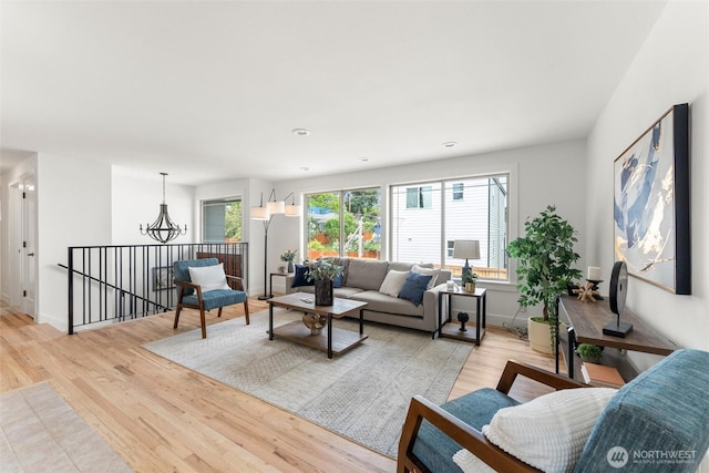11242 Fremont Ave N Unit B, Seattle, WA 98133 - living room with light wood-style floors, a chandelier, and baseboards
