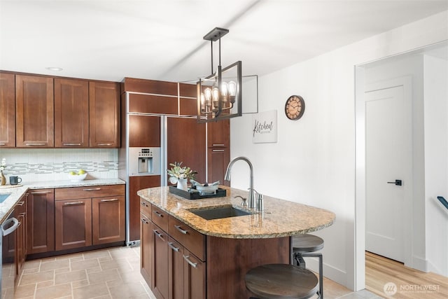 11242 Fremont Ave N Unit B, Seattle, WA 98133 - kitchen with a sink, a kitchen island with sink, a chandelier, a kitchen bar, and light stone counters