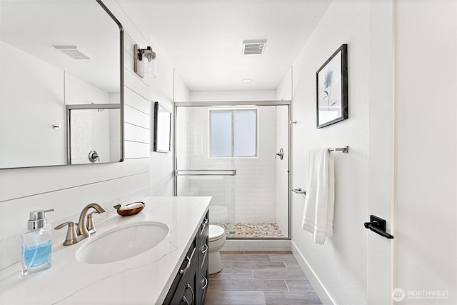 11242 Fremont Ave N Unit B, Seattle, WA 98133 - bathroom featuring a shower stall, vanity, toilet, baseboards, and wood finished floors