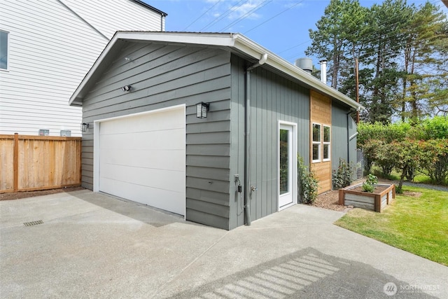 11242 Fremont Ave N Unit B, Seattle, WA 98133 - garage with concrete driveway and fence