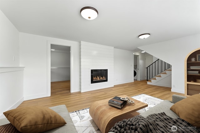 11242 Fremont Ave N Unit B, Seattle, WA 98133 - living area with stairs, wood finished floors, a large fireplace, and washer / clothes dryer