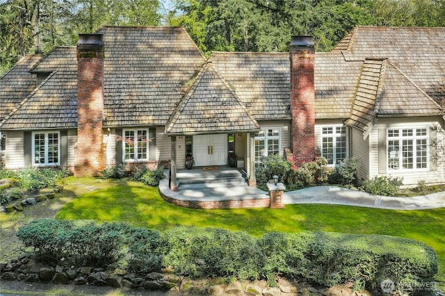 8150 Evergreen Ln, Mercer Island, WA 98040 - rear view of house with a chimney, a yard, and brick siding