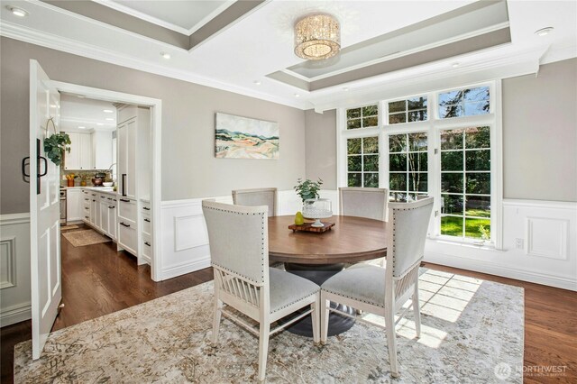 8150 Evergreen Ln, Mercer Island, WA 98040 - dining room featuring crown molding, wainscoting, dark wood-style flooring, and a raised ceiling