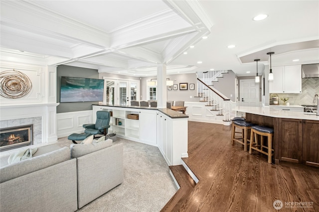 8150 Evergreen Ln, Mercer Island, WA 98040 - living area with a decorative wall, a premium fireplace, dark wood-style flooring, stairs, and beam ceiling
