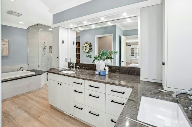 8150 Evergreen Ln, Mercer Island, WA 98040 - bathroom featuring crown molding, a stall shower, vanity, a garden tub, and recessed lighting